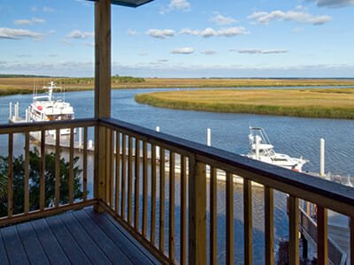 Patio, marina boats and marsh at Hidden Harbor Yacht Club and Residences in Brunswick, Georgia