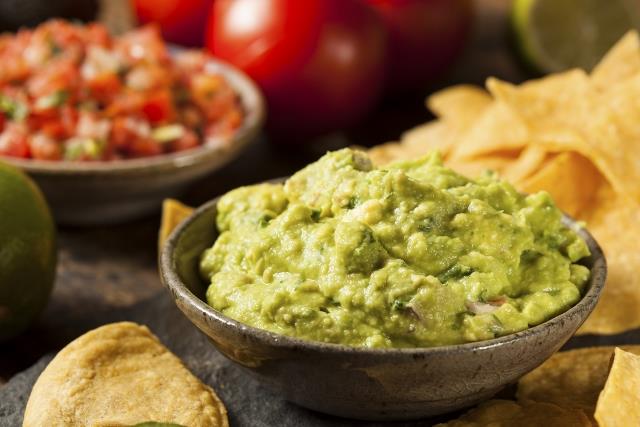 Green Homemade Guacamole with Tortilla ChipsGreen Homemade Guacamole with Tortilla Chips