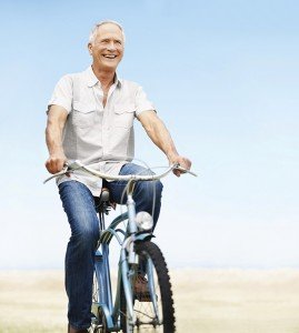 Happy mature man rides his bicycle-copyspace