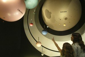 WASHINGTON - AUGUST 5: Two children look at a model of the Solar System at the Smithsonian National Air and Space Museum August 5, 2002 at the museum in Washington, DC. With hundreds of artifacts on display, the museum is one of the most visited sites in Washington. (Photo by Alex Wong/Getty Images)